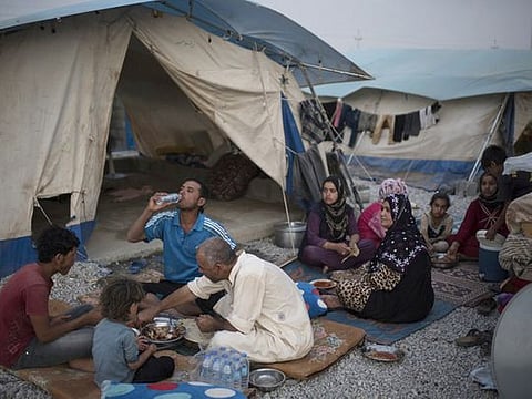 File photo: An internally displaced Iraqi family from Saladin breaks their day long fast during their first Ramadan iftar in the newly opened Ashti camp on June 24, 2015.