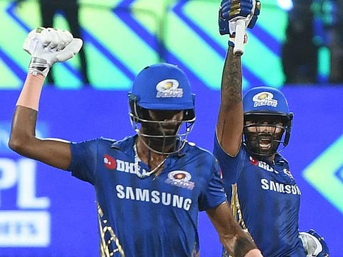 Mumbai Indians cricketers Hardik Pandya (L) and Surya Kumar Yadav (R) celebrate after winning the 2019 Indian Premier League (IPL) first Qualifier Twenty20 cricket match between Chennai Super Kings and Mumbai Indians at the MA Chidambaram stadium in Chennai on May 7, 2019. 