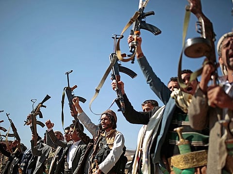 Tribesmen loyal to Houthi rebels hold up their weapons as they attend a gathering to show their support for the ongoing peace talks in Sanaa, Yemen.