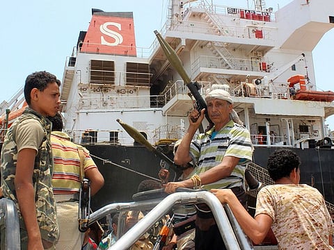 A Yemeni Houthi rebel fighter carries a rocket-propelled grenade launcher (RPG) as he rides with others in the back of a pickup truck during withdrawal from Saleef port in the western Red Sea Hodeida province