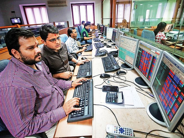 Indian traders work at a brokerage firm in Mumbai.