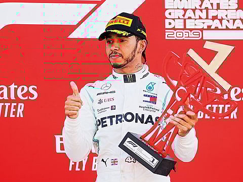 Mercedes’ Lewis Hamilton celebrates after winning the Spanish Grand Prix, pushing Valtteri Bottas to second spot.