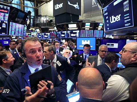 Traders work on the floor of the New York Stock Exchange (NYSE) moments before the first trade for the ride-hailing company Uber as it makes its highly anticipated initial public offering (IPO) on May 10, 2019 in New York City.