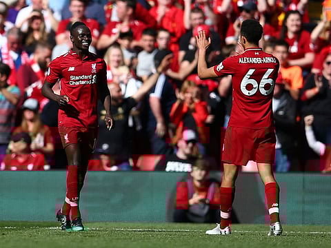 Liverpool's Sadio Mane, left, celebrates with Liverpool's Trent Alexander-Arnold after scoring his side's second goal during the English Premier League soccer match between Liverpool and Wolverhampton Wanderers at the Anfield stadium in Liverpool, England, on Sunday, May 12, 2019. 
