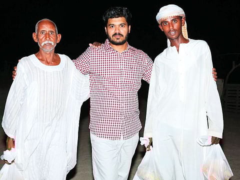 Fazil Musthafa with shepherds at animal farms in the desert.
