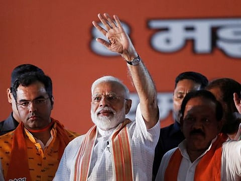 India's Prime Minister Narendra Modi waves towards his supporters during an election campaign rally in New Delhi, India, May 8, 2019.
