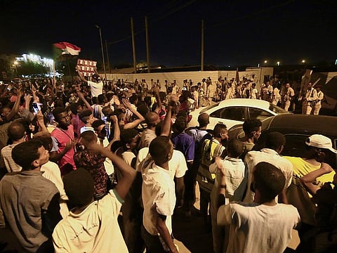 Sudanese people gather as protests continue near the site of Sudan's military headquarters in central Khartoum on May 13, 2019.