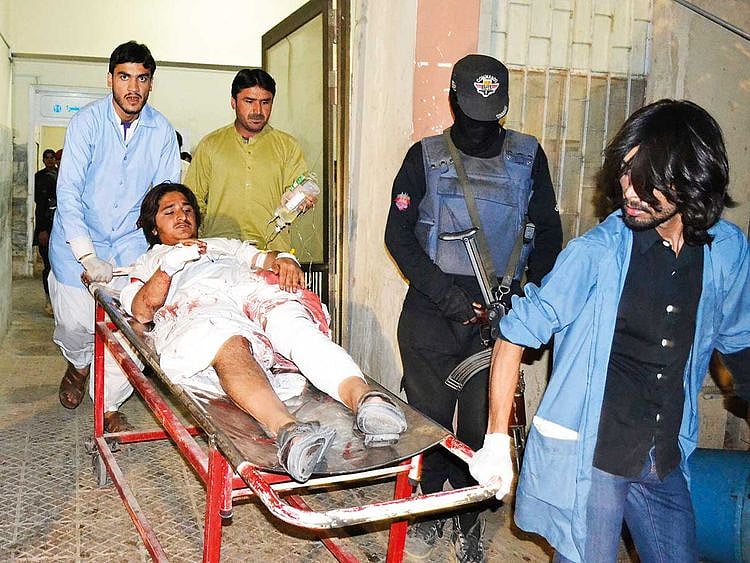 Volunteers rush an injured victim of bombing