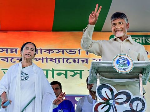 Andhra Pradesh Chief Minister N Chandrababu Naidu flashes victory sign as he participates in an election rally by West Bengal Chief Minister Mamata Banerjee, during the ongoing Lok Sabha elections, in Midnapore district, Thursday, May 9, 2019.
