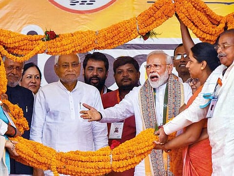 Prime Minister Modi and Bihar Chief Minister Nitish Kumar being garlanded during an election rally at Paliganj in Patna on Wednesday.