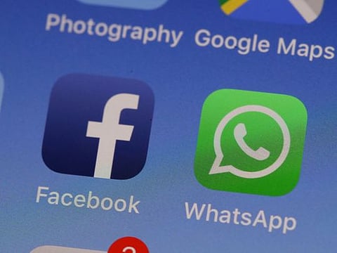 The WhatsApp messaging app is displayed on an Apple iPhone in San Anselmo, California. 