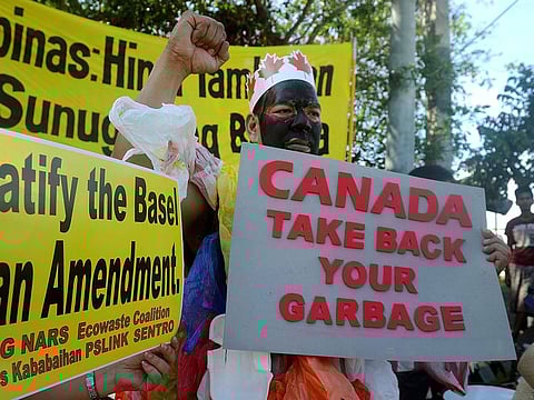 This file photo taken on September 9, 2015, shows environmental activists rallying outside the Philippine Senate in Manila to demand that scores of containers filled with household rubbish be shipped back to Canada.