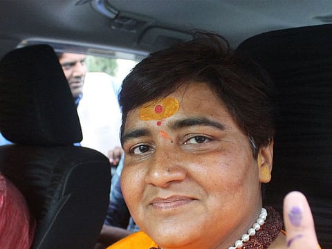 Pragya Singh Thakur, leader of ruling Bharatiya Janata Party (BJP), shows her ink-marked finger after casting her vote, outside a polling station in Bhopal, India, May 12, 2019. 