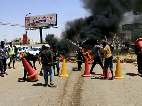 Sudanese protesters burn tyres and barricade the road leading to al-Mek Nimir Bridge crossing over Blue Nile; that links Khartoum North and Khartoum, in Sudan May 13, 2019.
