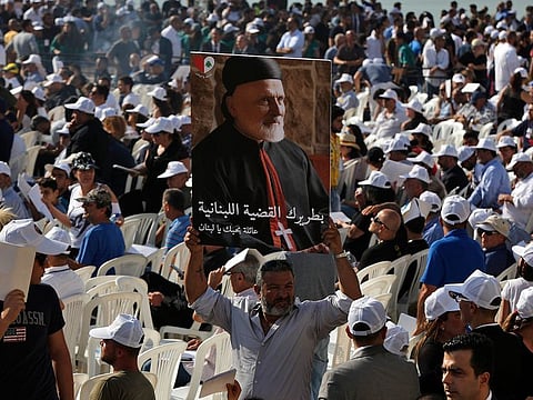 A mourner holds up a picture of former Maronite Patriarch Cardinal Nasrallah Sfeir, during his funeral Mass, at the seat of the Maronite Church, in the village of Bkirki, north of Beirut. 