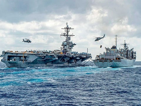 The Nimitz-class aircraft carrier USS Abraham Lincoln (CVN 72) while conducting a replenishment-at-sea with the fast combat support ship USNS Arctic (T-AOE 9), while MH-60S Sea Hawk helicopters assigned to the "Nightdippers" of Helicopter Maritime Strike Squadron (HSM) 5, transfer stores between the ships. 