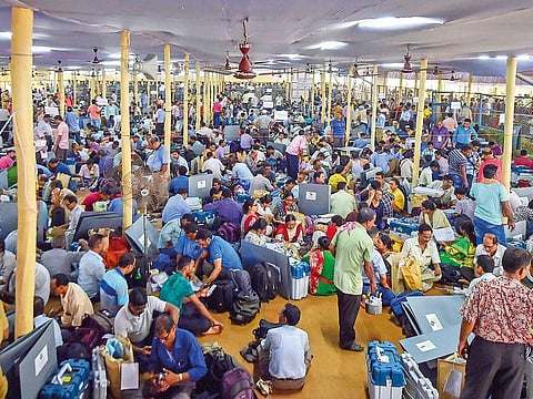 Polling officials check electronic voting machines and other equipment before leaving for their respective booths, at a distribution centre in Kolkata on Saturday. 