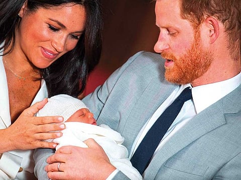 Prince Harry and his wife Meghan with their newborn baby son, Archie Harrison Mountbatten-Windsor.