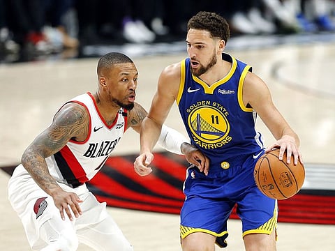 Klay Thompson #11 of the Golden State Warriors handles the ball against Damian Lillard #0 of the Portland Trail Blazers during the second half in game three of the NBA Western Conference Finals at Moda Center on May 18, 2019 in Portland, Oregon.