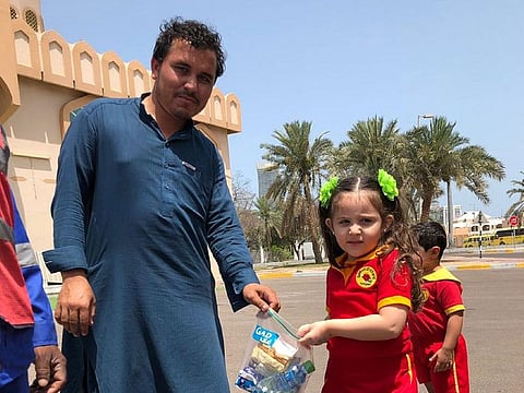 Children distributing Iftar boxes to labourers.