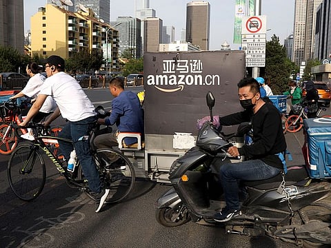 A delivery man bearing US commerce giant Amazon's brand is seen in downtown Beijing. 