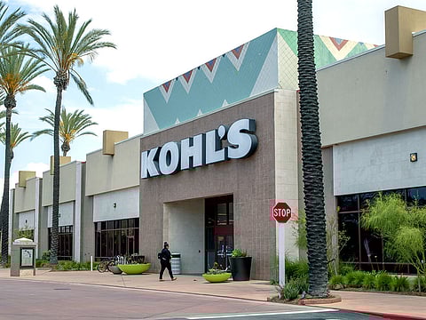 A shopper walks towards a Kohl's Corp. department store in Cerritos, California.