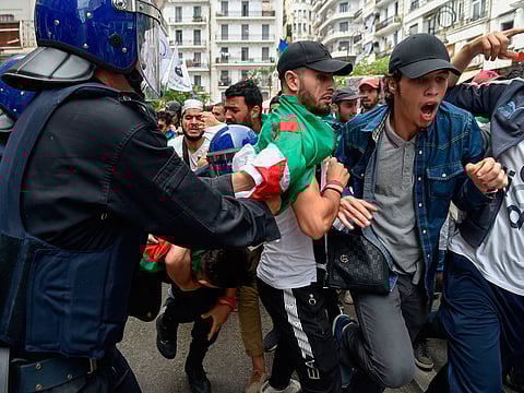 Algerian students and police confront each other during a demonstration near the government palace in the capital Algiers.