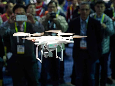 In this Jan. 7, 2016 file photo, a drone hovers at the DJI booth during CES International in Las Vegas. 