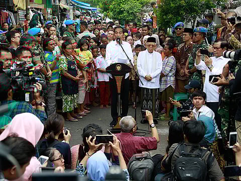 Indonesian President Joko Widodo, centre, delivers his victory speech as his running mate Ma'ruf Amin, center right, listens, at a low-income neighborhood in Jakarta, Indonesia, Tuesday, May 21, 2019. 