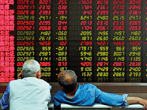 A brokerage in Beijing. Shares edged down in Asia yesterday after a rebound in technology stocks helped power an overnight rally on Wall Street.