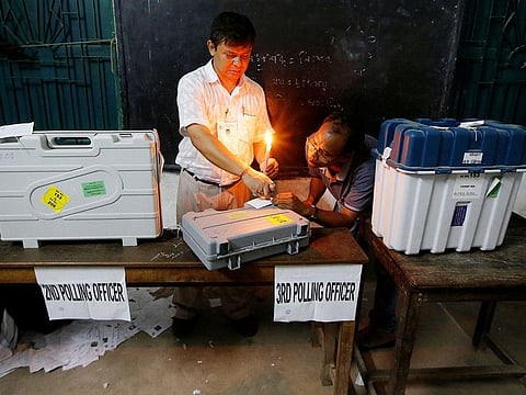 Polling officials seal an Electronic Voting Machine (EVM) and a Voter Verifiable Paper Audit Trail (VVPAT) machine at a polling station after the end of the last phase of the general election in Kolkata, on May 19, 2019. 