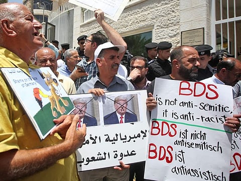 Protesters stage a demonstration outside Germany's Representative Office in Ramallah in the Palestinian West Bank on May 22, 2019, following the Bundestag's (German parliament) condemnation of the Boycott, Divestment, Sanctions (BDS) movement as anti-Semitic.