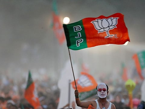 A supporter of India's ruling Bharatiya Janata Party (BJP) waves the party flag