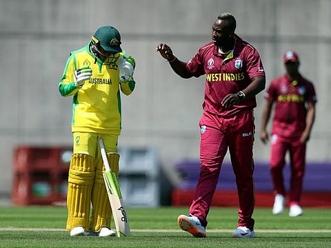 West Indies' Andre Russell (right) checks on Australia's Usman Khawaja (left) after hitting him on the head with a bouncer during the World Cup warm-up match at the Nursery Ground, Southampton, England.