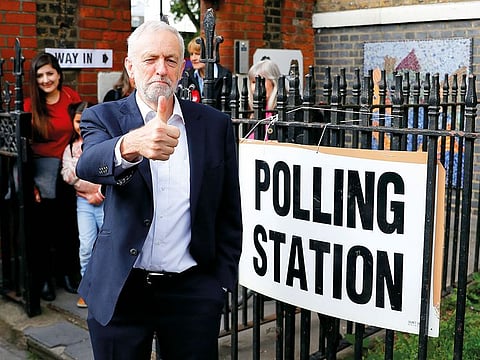 Britain's Labour Party leader Jeremy Corbyn gestures after voting at a local polling station in his constituency in London, Britain.