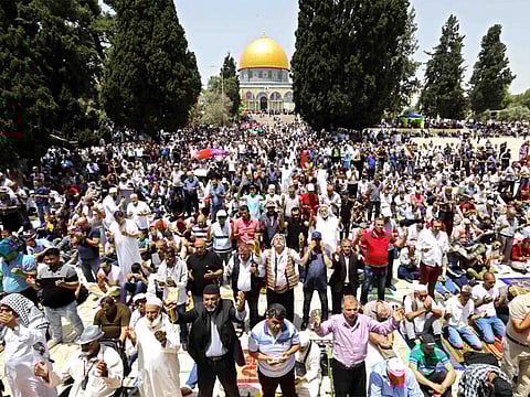 Palestinians pray in front of the Dome of the Rock mosque in the Al Aqsa Mosque compound in Jerusalem.
