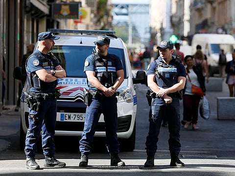 Police patrol the streets during the manhunt of a suspected suitcase bomber in central Lyon, France.