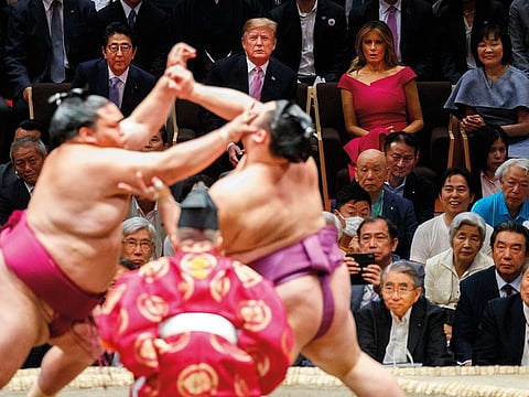 President Donald Trump attends the Tokyo Grand Sumo Tournament with Japanese Prime Minister Shinzo Abe at Ryogoku Kokugikan Stadium.