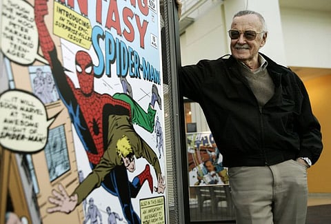 In this March 21, 2006 file photo, comic book creator Stan Lee stands beside a Spider-Man comic book cover in the Marvel Super Heroes Science Exhibition at the California Science Center in Los Angeles. 