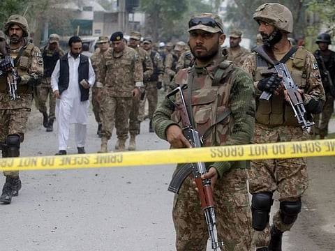 Pakistan soldiers cordon off the area after a bombing in Peshawar in this file picture (Mohammad Sajjad/AP)