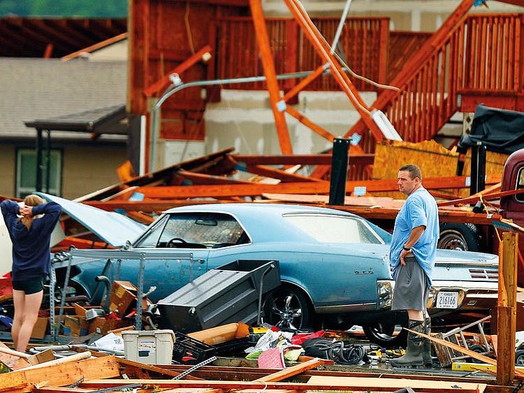 A man and woman inspect the damage