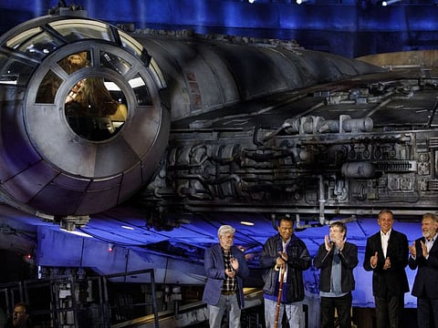 From left: George Lucas, founder of Lucasfilm Ltd, actor Billy Dee Williams, Actor Mark Hamill, Bob Iger and actor Harrison Ford applaud in front of the Millennium Falcon during the unveiling of Star Wars: Galaxy’s Edge at Walt Disney Co.’s Disneyland theme park in Anaheim, California on Wednesday.