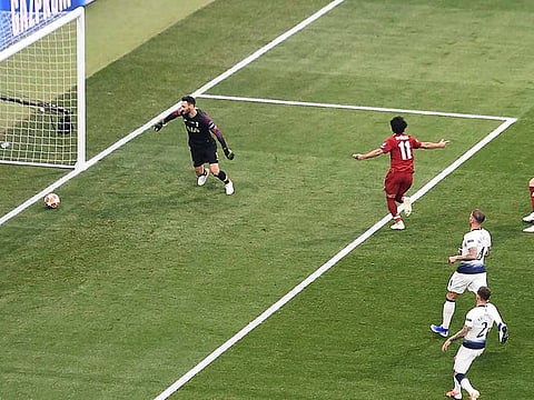 Liverpool's Egyptian midfielder Mohamed Salah shoots from the penalty spot to score his team's first goal during the UEFA Champions League final football match 