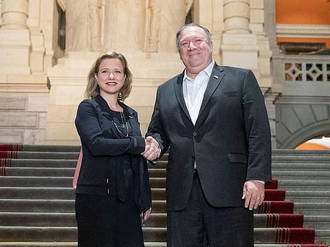 US Secretary of State Mike Pompeo, right, and Christa Markwalder, member of the Swiss National Council, shake hands at the Swiss parliament building in Bern, Switzerland, Saturday, June 1, 2019. 