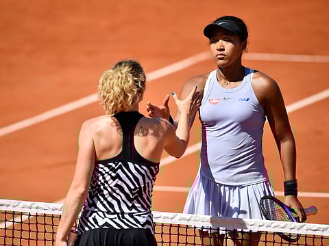 A distraught Naomi Osaka (right) shakes hands with her conquerer Katerina Siniakova of the Czech Republic at French Open yesterday.