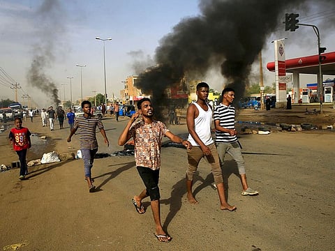 Sudanese protesters chant slogans along a street and demanding that the country's Transitional Military Council hand over power to civilians in Khartoum, Sudan.