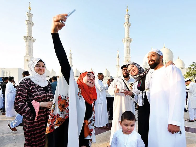 A family poses for a selfie after Eid prayers 