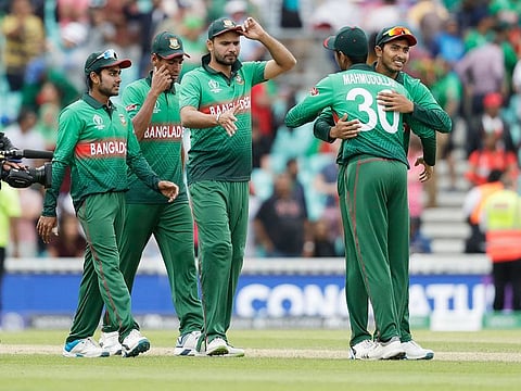Bangladesh's captain Mashrafe Mortaza, centre, celebrates with his teammates as they walk off after winning against South Africa at the Oval in London, on Sunday.
