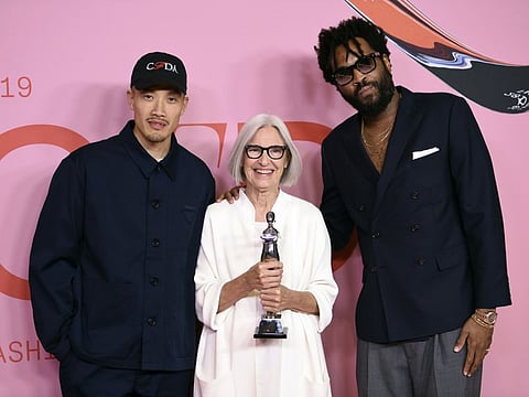 Public School designers Dao-Yi Chow, left, and Maxwell Osborne, right, pose with honoree Eileen Fischer in the winner's walk with the Positive change award at the CFDA Fashion Awards at the Brooklyn Museum.