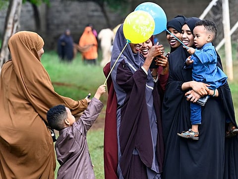 Women click pictures on their mobile phones after attending Eid Al Fitr prayers in Nairobi, Kenya.